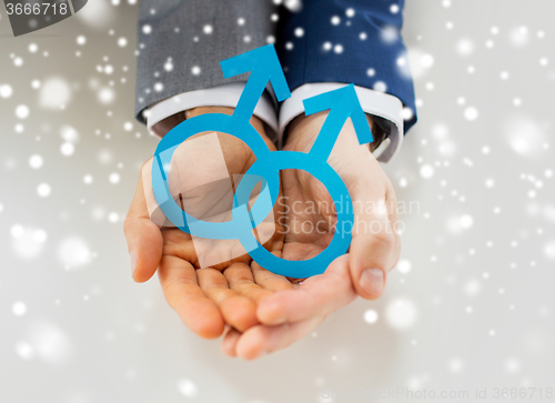 Image of close up of happy male gay couple with love symbol