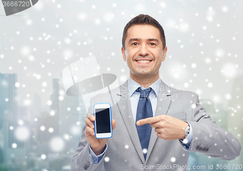 Image of happy businessman showing smartphone screen