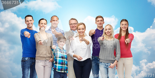 Image of group of smiling people pointing finger on you