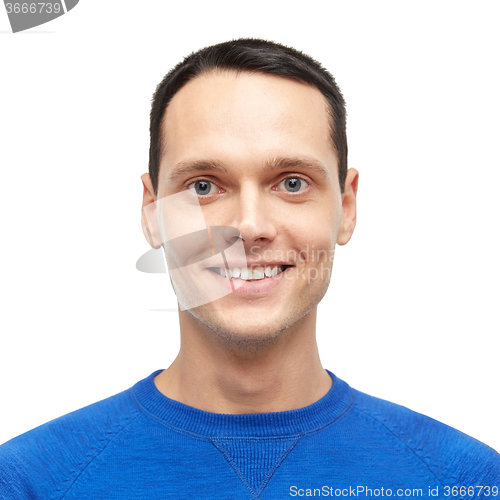 Image of smiling young man in blue pullover portrait