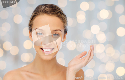 Image of smiling young woman face and shoulders