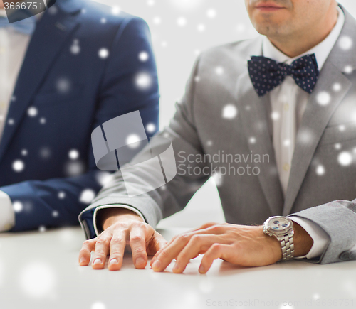 Image of close up of happy male gay couple hands on wedding