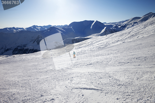 Image of Skier on slope in sun day