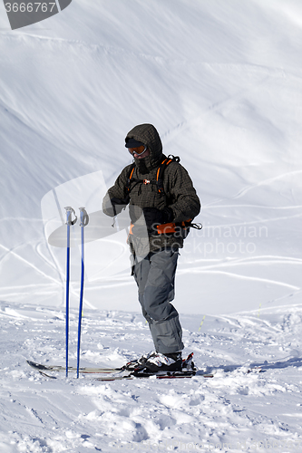 Image of Skier on top of ski slope at nice day