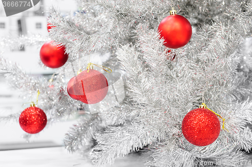 Image of Red baubles on silver artificial christmas tree