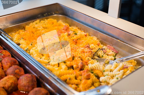 Image of close up of pasta and meatballs on catering tray