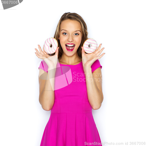 Image of happy woman or teen girl with donuts