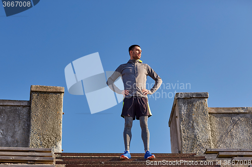 Image of happy man on stadium stair