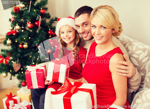 Image of smiling family holding many gift boxes