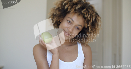 Image of Young Woman With Green Apple In Hands