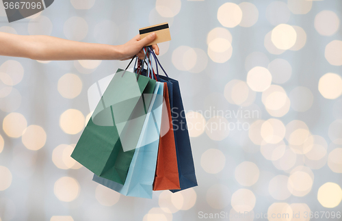 Image of close up of woman with shopping bags and bank card