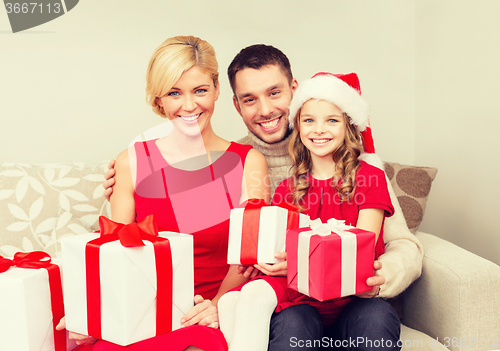 Image of smiling family holding many gift boxes