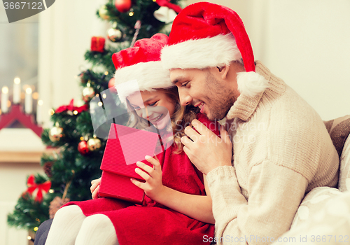 Image of smiling father and daughter opening gift box