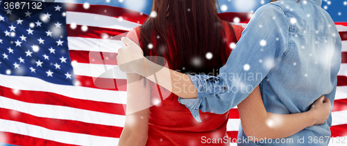 Image of close up of women couple over american flag