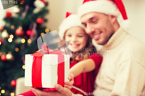 Image of close up of father and daughter with gift box