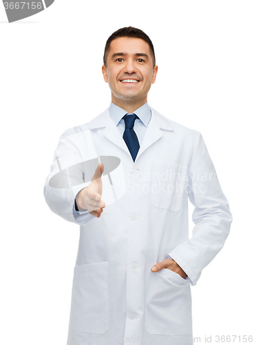 Image of smiling male doctor in white coat givin hand