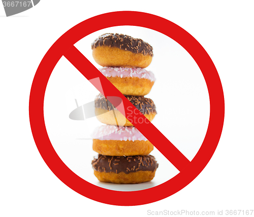 Image of close up of glazed donuts pile behind no symbol