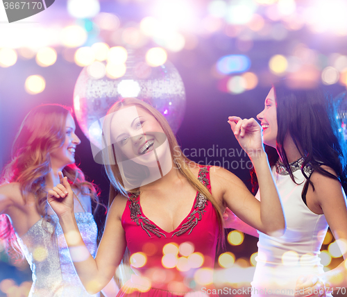 Image of happy women dancing at night club