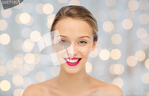 Image of smiling young woman face and shoulders