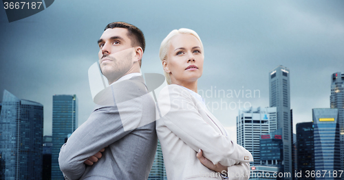 Image of businessman and businesswoman outdoors