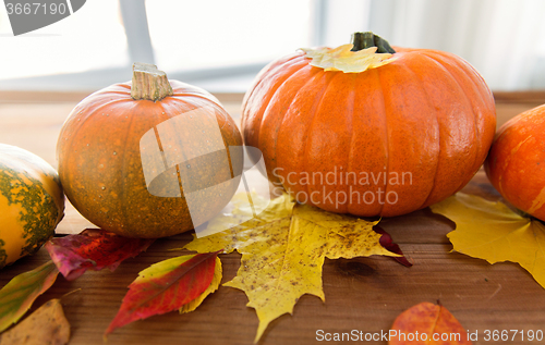 Image of close up of pumpkins on wooden table at home