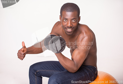 Image of Strong and muscular guy with dumbbell on white background