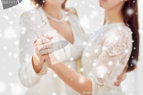 Image of close up of happy married lesbian couple dancing