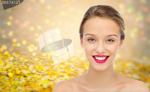 Image of smiling young woman face and shoulders