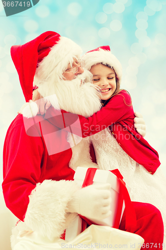 Image of smiling little girl with santa claus