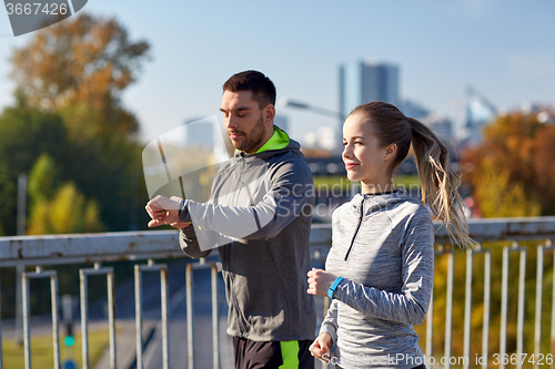 Image of couple running over city highway bridge