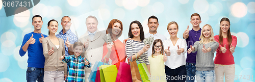 Image of happy people with shopping bags showing thumbs up