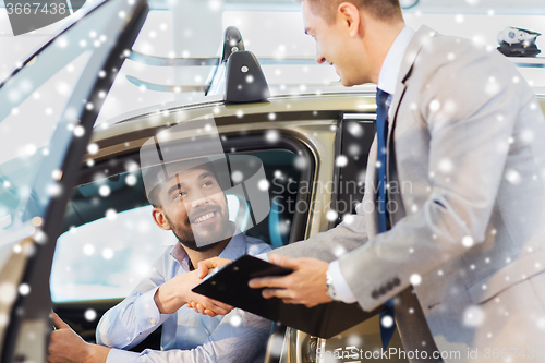 Image of happy man with car dealer in auto show or salon