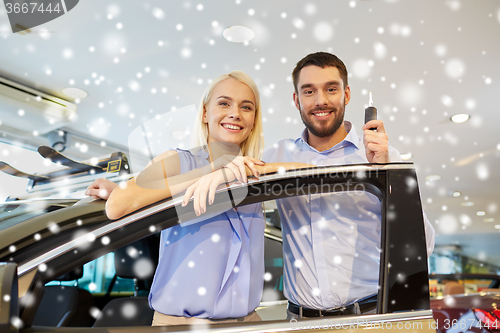 Image of happy couple buying car in auto show or salon