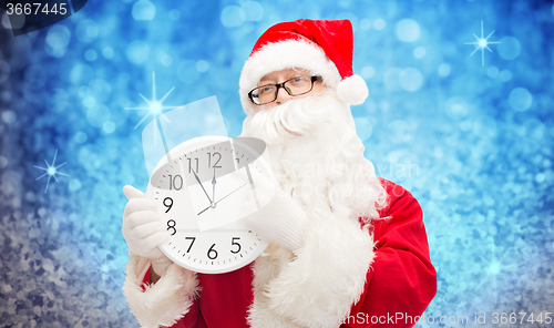 Image of man in costume of santa claus with clock