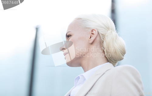 Image of young businesswoman over office building