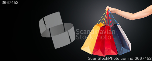 Image of close up of hand holding shopping bags