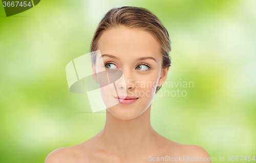 Image of smiling young woman face and shoulders