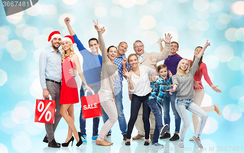 Image of happy people with shopping bags having fun