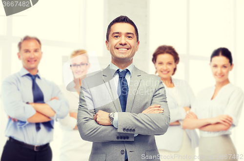 Image of happy smiling business team over office room