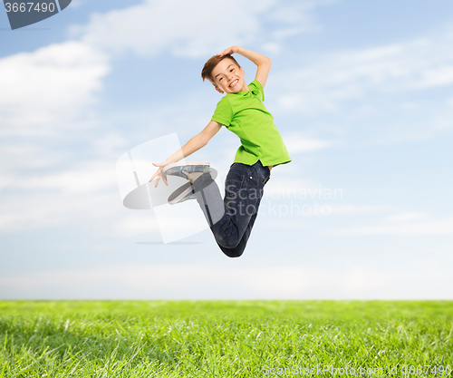 Image of smiling boy jumping in air