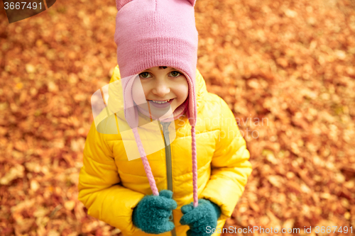 Image of happy little girl in autumn park