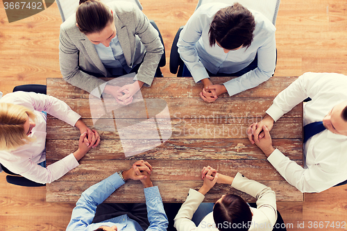 Image of close up of business team sitting at table