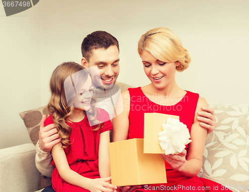 Image of happy family opening gift box