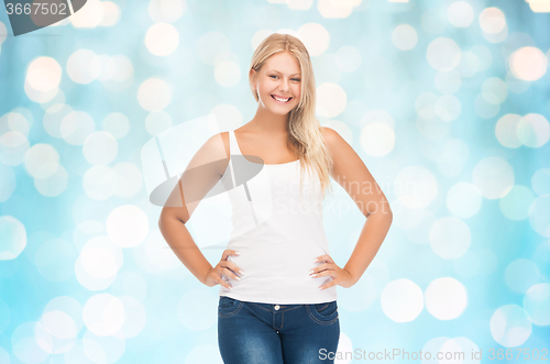 Image of smiling young woman in blank white shirt and jeans