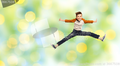 Image of happy smiling boy jumping in air