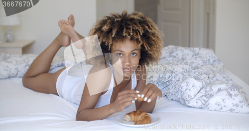 Image of Young Woman Enjoying Breakfast In Bed