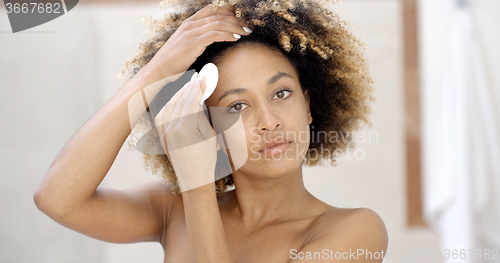 Image of Young Woman Cleaning Skin