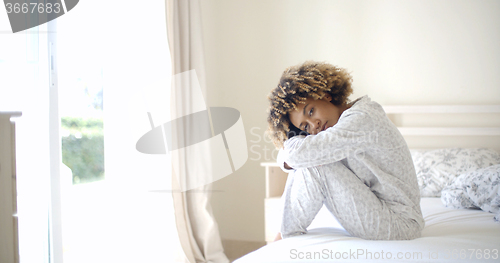 Image of Sad Woman Sitting On The Bed