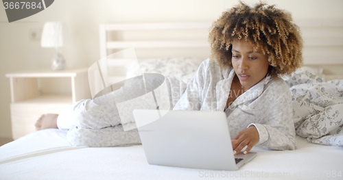 Image of Cute Woman Using Laptop On Bed.