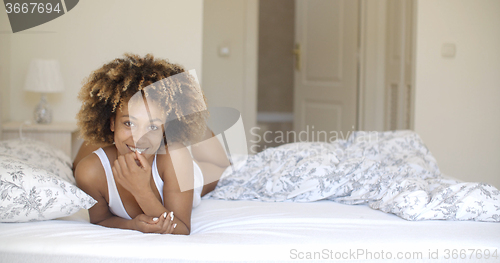 Image of Woman in white underwear moves on the bed .